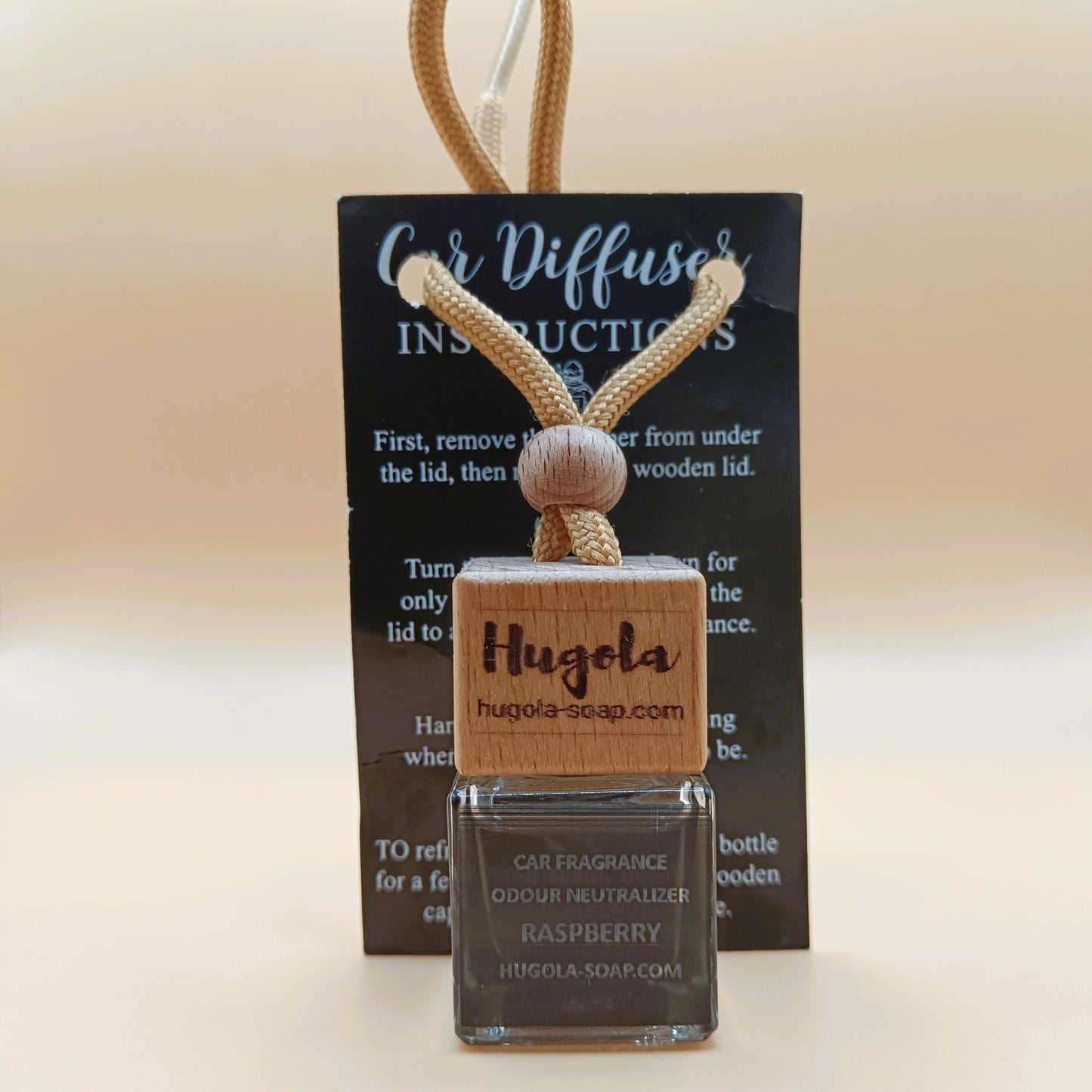 Hugola car fragrance diffuser, Raspberry scent, displayed with instruction card and wooden cap