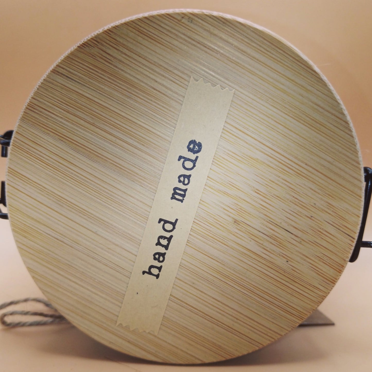 Soil and Solace Hand and Body Scrub, close-up showing "hand made" label on bamboo lid