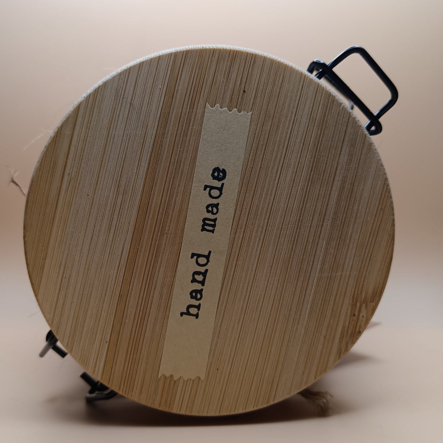 Soil and Solace Hand and Body Scrub, close-up showing wooden bamboo lid with 'hand made' label