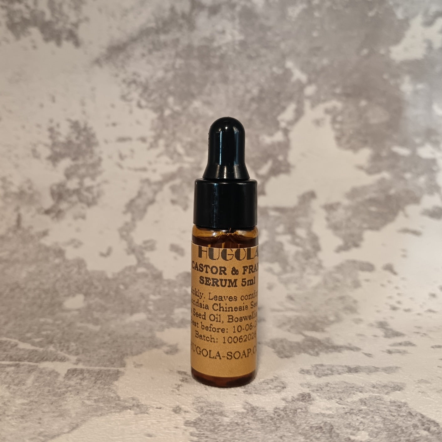 5ml facial serum mini bottle for skincare routine on marble surface