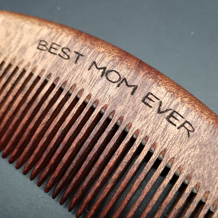 Close up to "Best Mom Ever"engraving on sandalwood comb