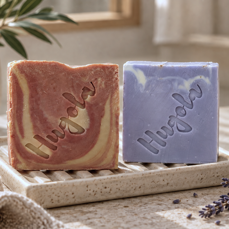 Two HUGOLA full size soap bars on a soap dish