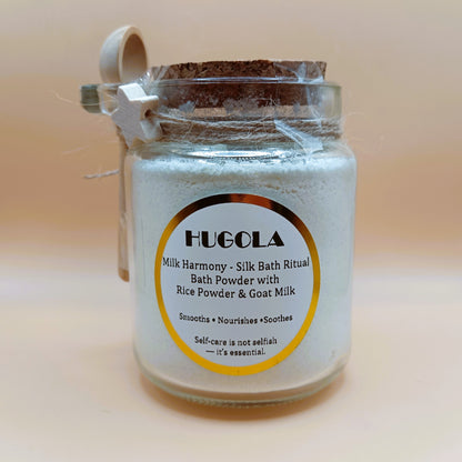 Glass jar of Milk Harmony bath powder with cork lid and wooden spoon, front label visible