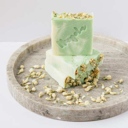 Emerald Jasmin Soap, three handmade natural palm-free soap bars with dried jasmine stacked together