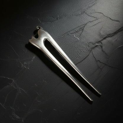 Wooden hair pin on a gray background