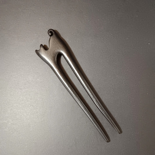 Wooden hair pin on a gray background