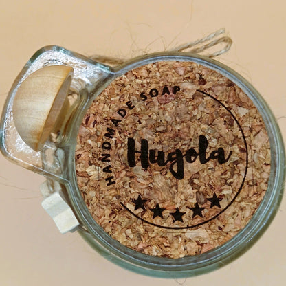 Milk Harmony bath powder jar with cork lid and attached wooden spoon, top view