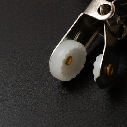 Close-up of a metal clip from towel hanger on a gray background