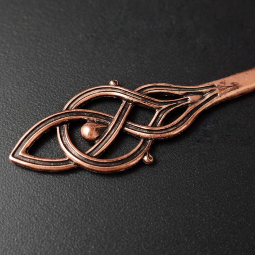 Close up to copper hairpin with Viking design 