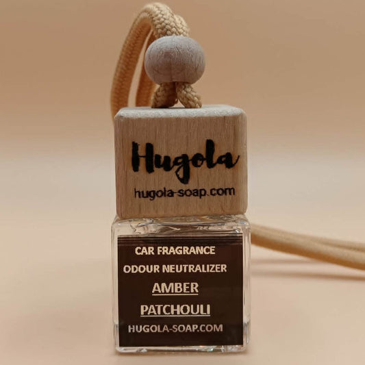 Hugola car fragrance "Amber Patchouli" with wooden holder on a beige background