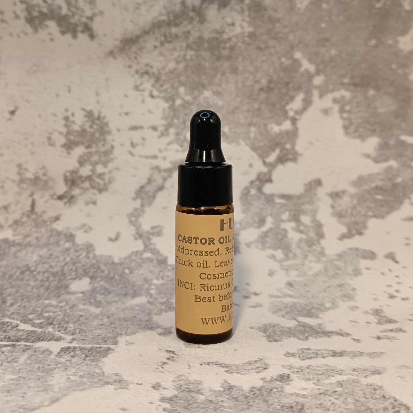 5ml castor oil travel bottle for lashes, brows and hair on marble background