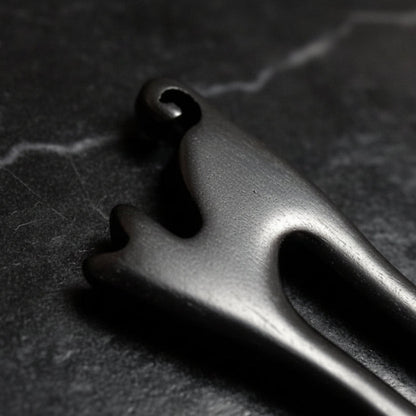 Close-up of cat shaped black hair pin