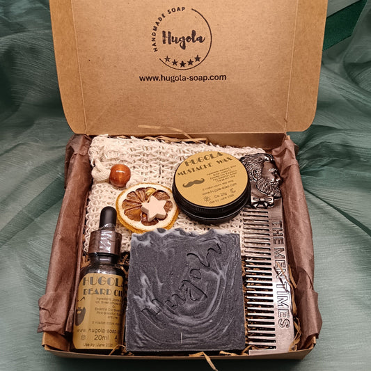 Grooming kit with soap, oil, and comb in a Hugola branded box on a green fabric background