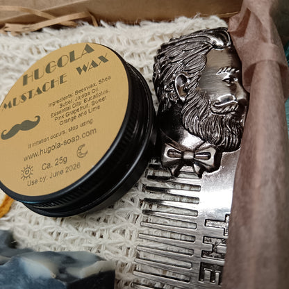 Hugola mustache wax container with decorative lid featuring a mustache design, placed on a textured surface.
