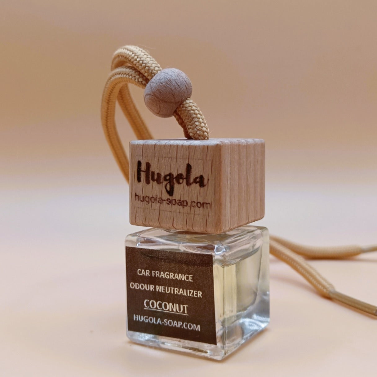 Hugola car fragrance diffuser, Coconut scent, angled view of glass bottle with wooden lid