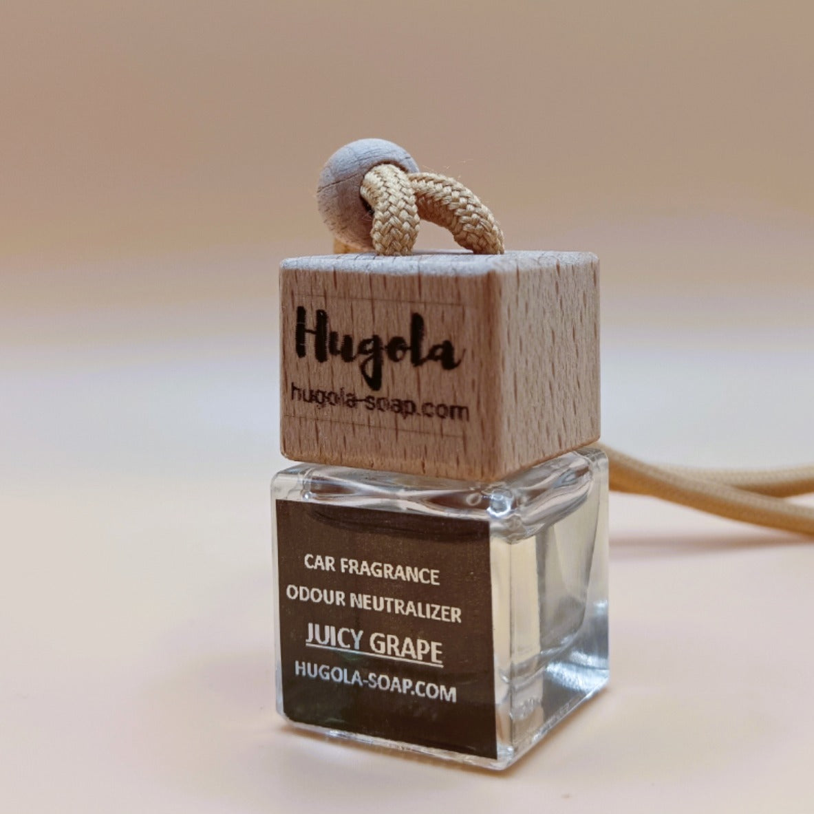 Hugola car fragrance diffuser, Juicy Grape scent, angled view of glass bottle with wooden lid