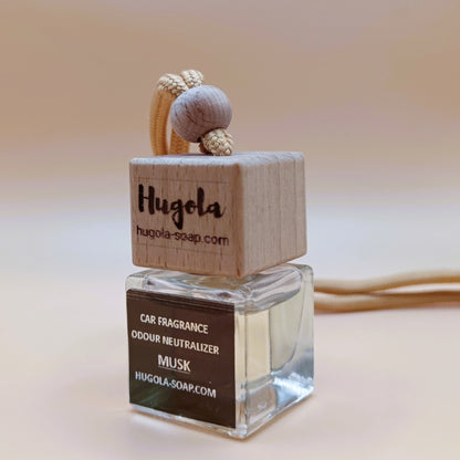 Hugola car fragrance diffuser, Musk scent, angled view of glass bottle with wooden lid