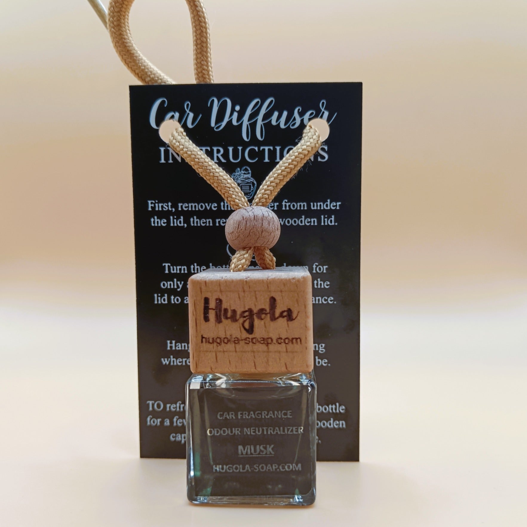 Hugola car fragrance diffuser, Musk scent, displayed with instruction card and wooden cap