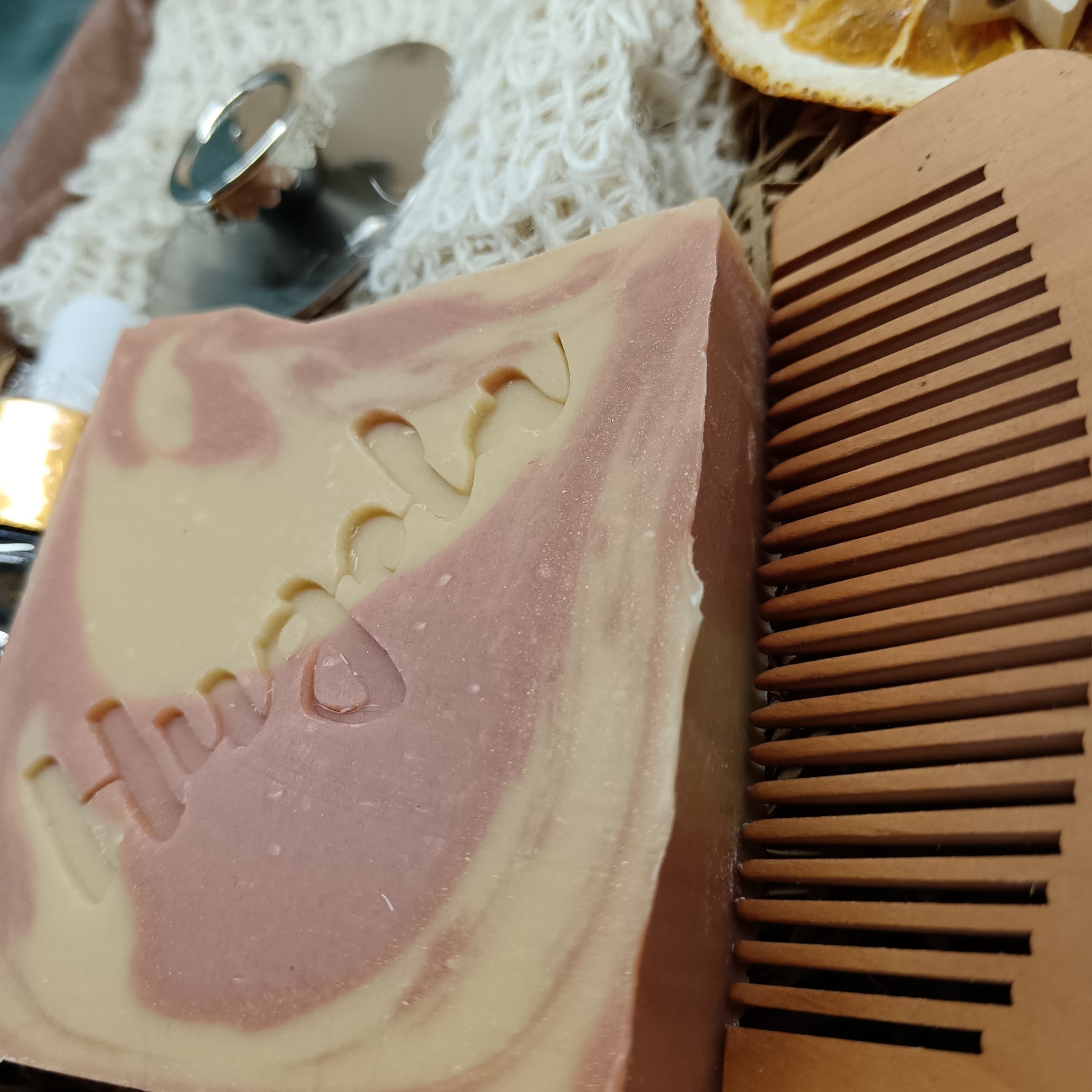 Bar of soap with a comb on a textured surface