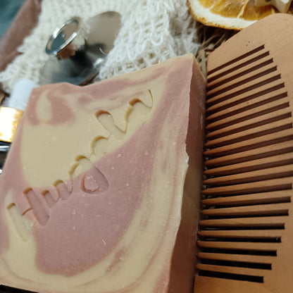Bar of soap with a comb on a textured surface