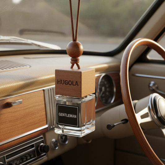 square small glass , seethrough bottle with square wooden cap ( cap the same size as bottle)and HUGOLA engraved, with black label covering one whole square side - white letters GENTLEMAN on the label. Bottle filled with seethrough fluid, facing left, hanging on a brown rope with brown, round bead, on the rear view mirror in the RETRO car - steering wheel on the right side