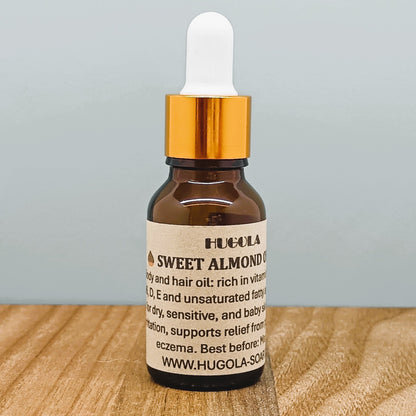 Sweet Almond Oil, natural cold-pressed plant oil in glass bottle