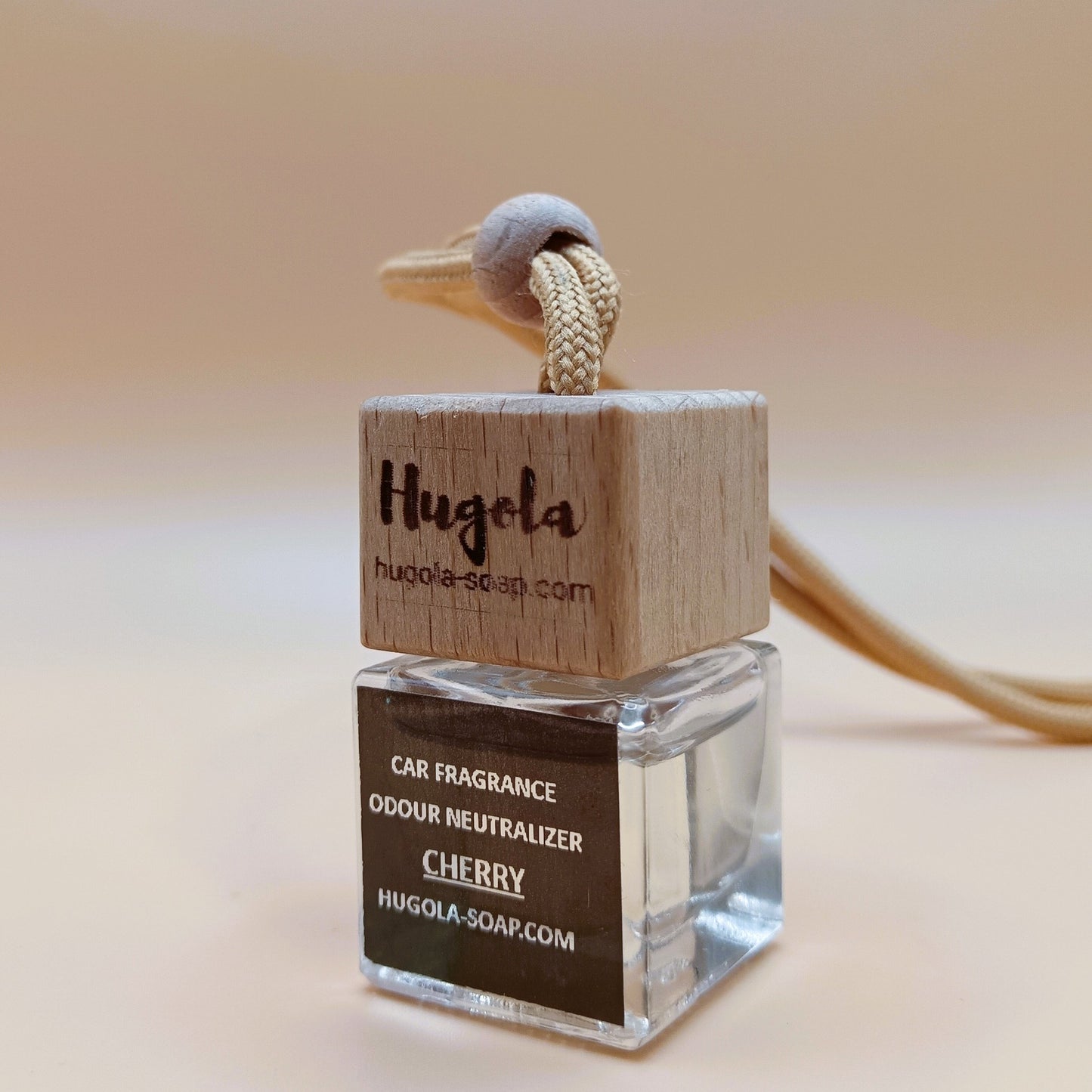 Hugola car fragrance diffuser, Cherry scent, angled view of glass bottle with wooden lid