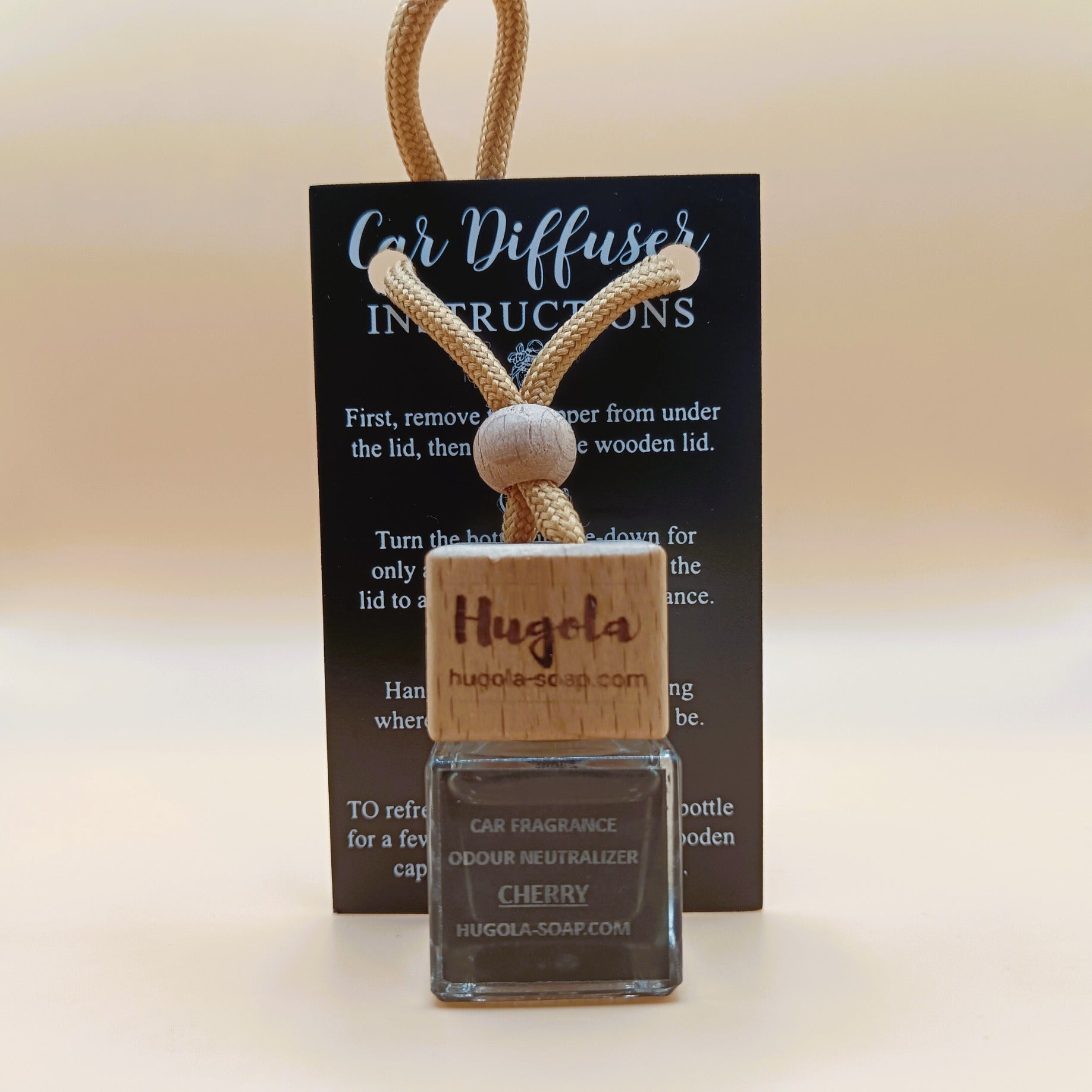 Hugola car fragrance diffuser, Cherry scent, displayed with instruction card and wooden cap